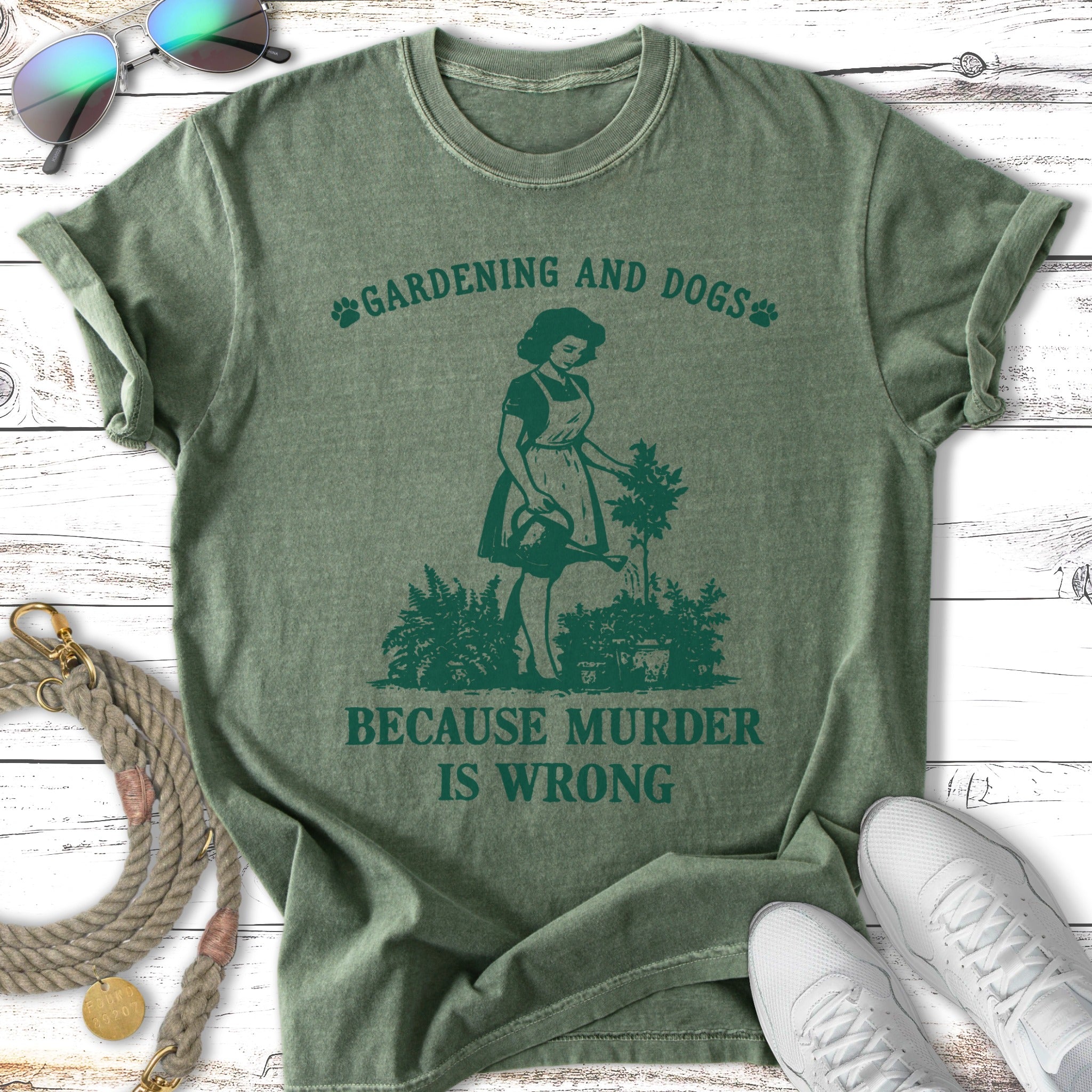 Green t-shirt with "Gardening and Dogs Because Murder Is Wrong" text and graphic.