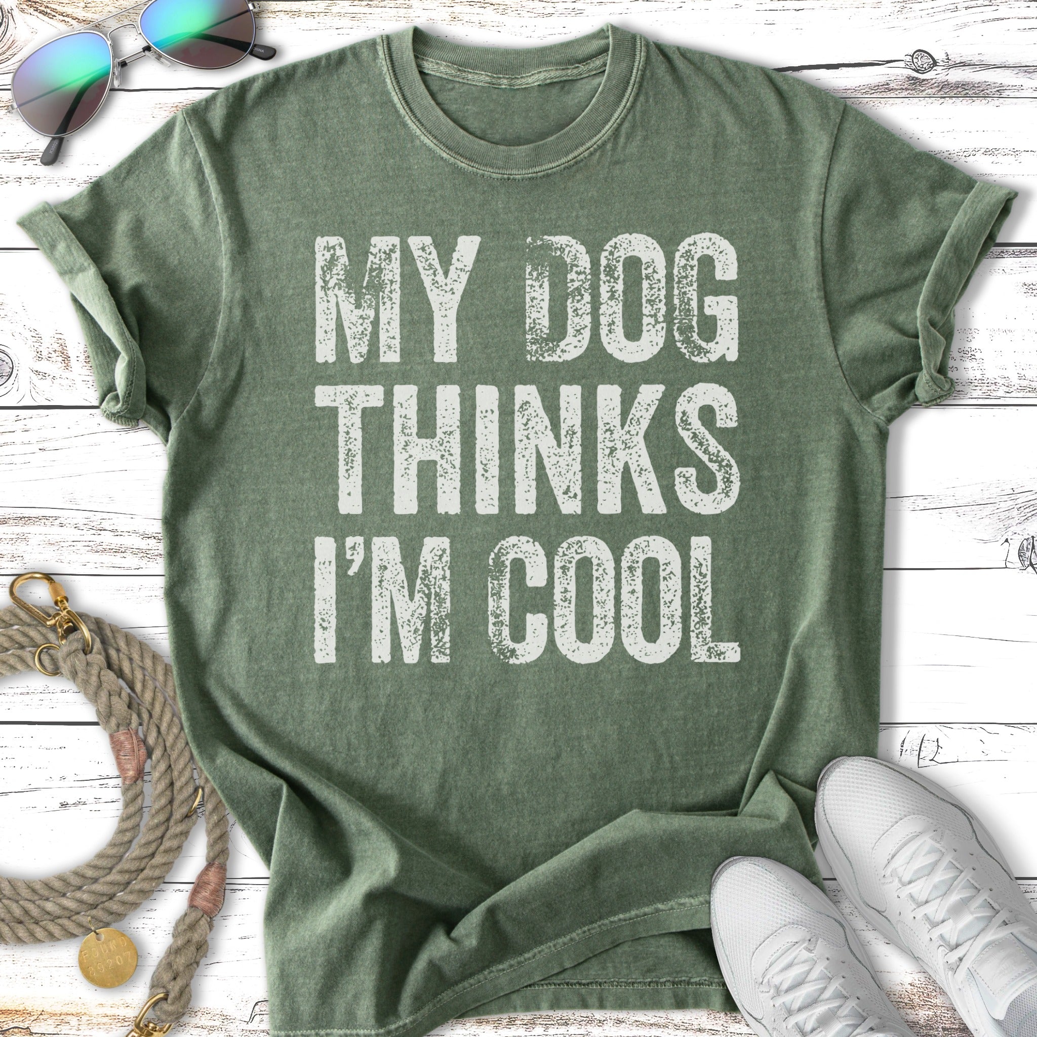 Green t-shirt with "MY DOG THINKS I'M COOL" in white distressed text.