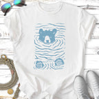 Blue bear swimming with paws visible, on a white t-shirt.