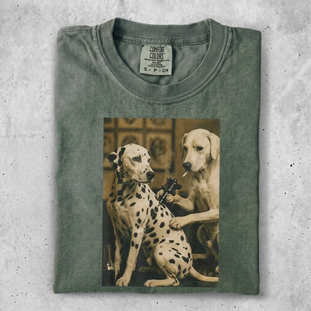 Two Dalmatians, one getting a tattoo, on a green t-shirt.