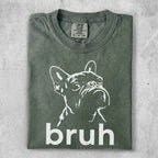 Green t-shirt with a white line drawing of a French bulldog and the word "bruh".