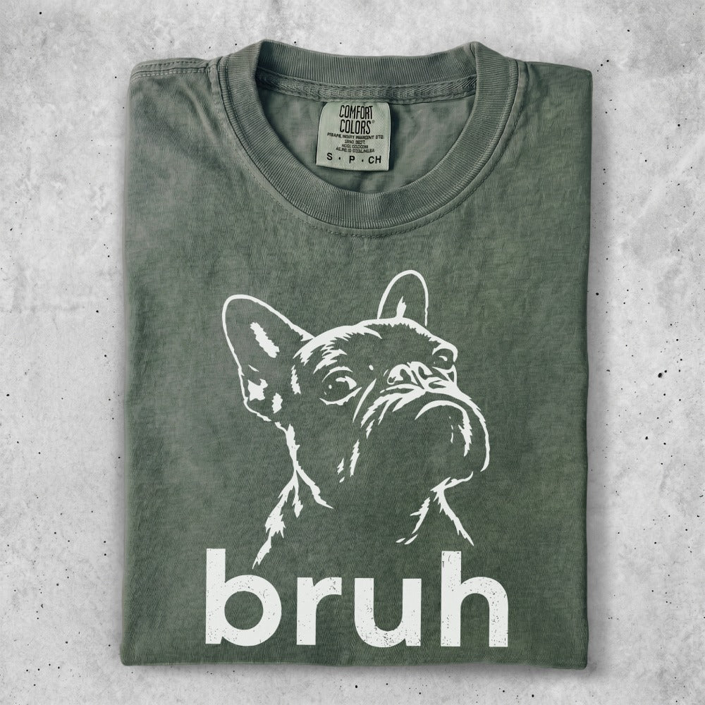 Green t-shirt with a white line drawing of a French bulldog and the word "bruh".