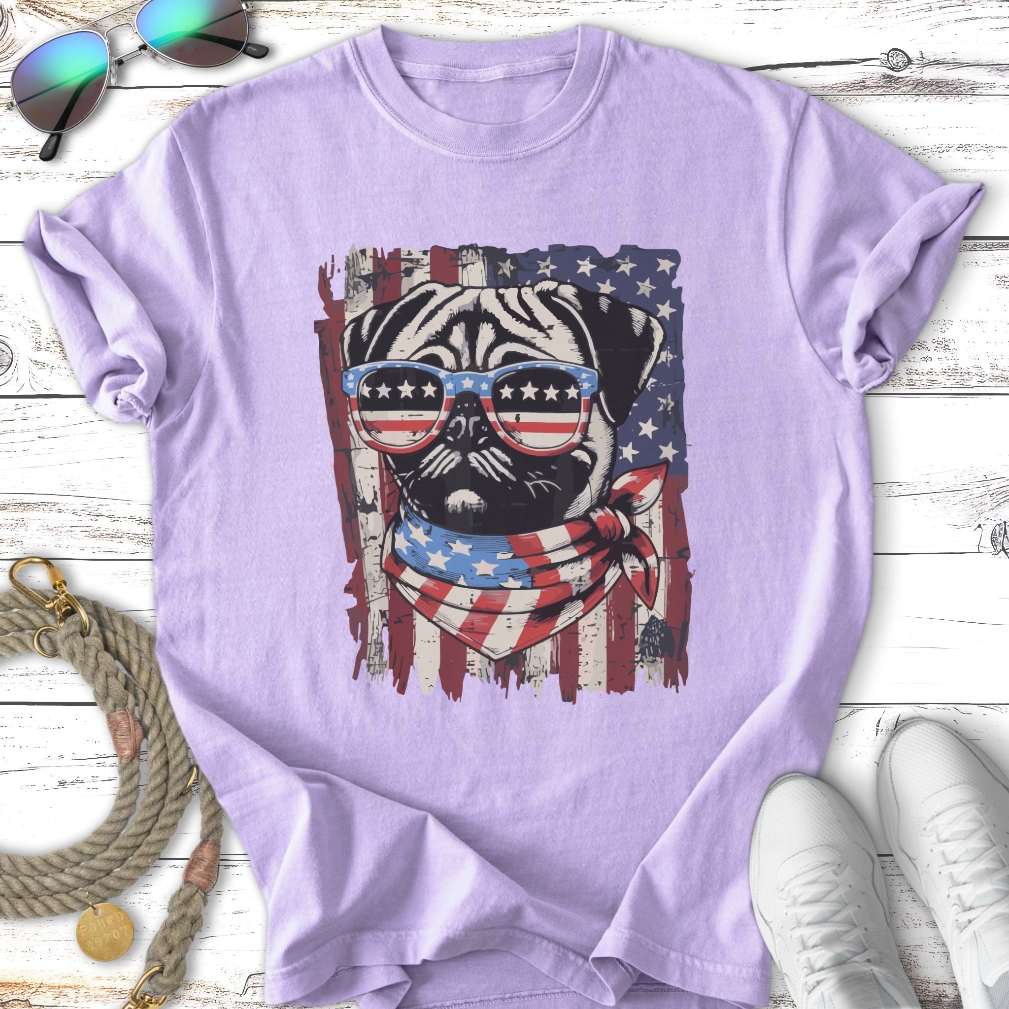 Pug wearing sunglasses and bandana with American flag design.