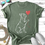 French bulldog holding a red heart balloon, outline sketch on a green t-shirt.