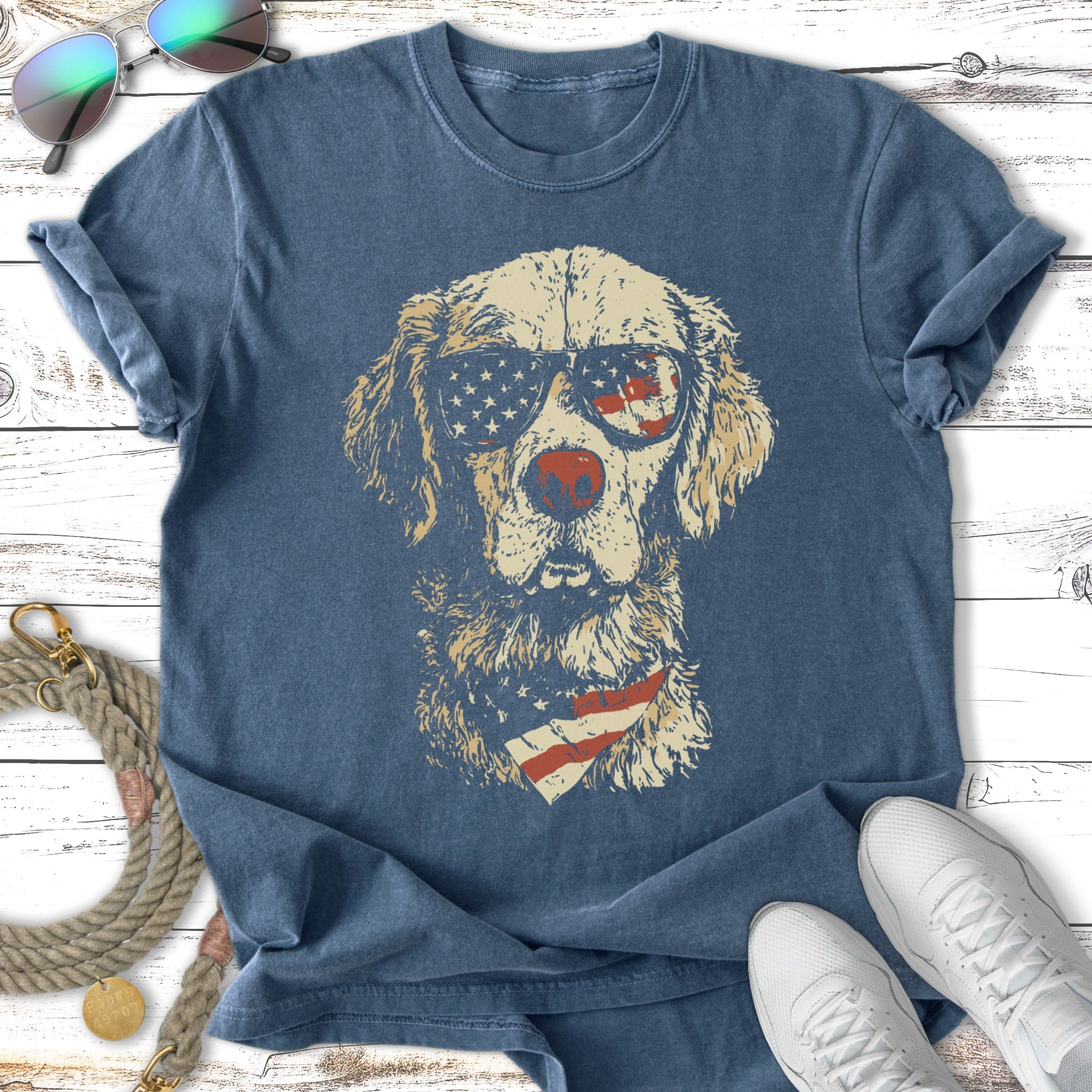 T-shirt featuring a dog wearing American flag sunglasses and bandana.