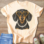 Dachshund wearing leopard glasses and diamond necklace printed on peach t-shirt.