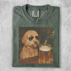 Labradoodle wearing sunglasses, looking at beer being poured into a mug.