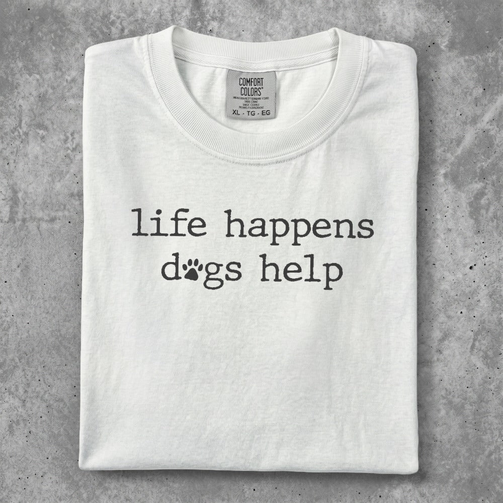 White t-shirt with "life happens dogs help" and dog paw print graphic.