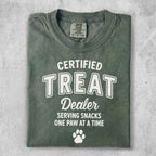 Green t-shirt with "CERTIFIED TREAT DEALER" and paw print.