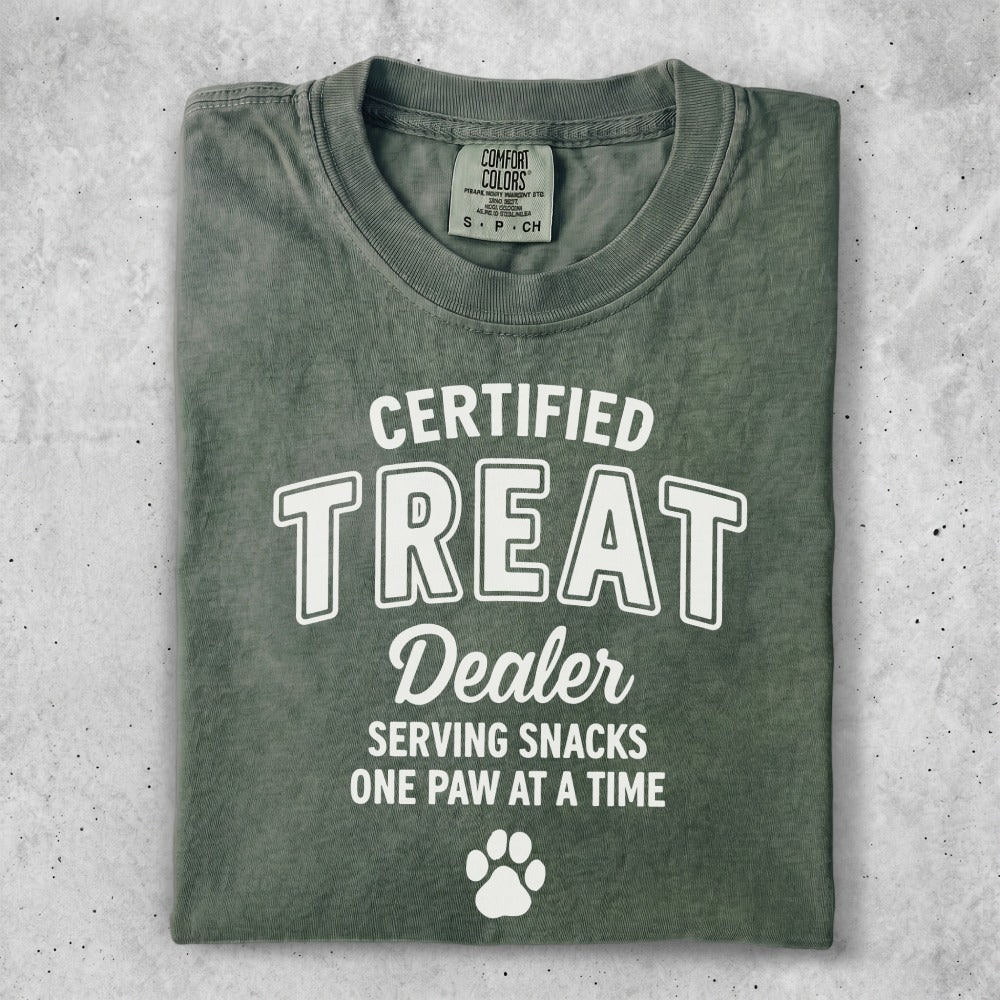 Green t-shirt with "CERTIFIED TREAT DEALER" and paw print.