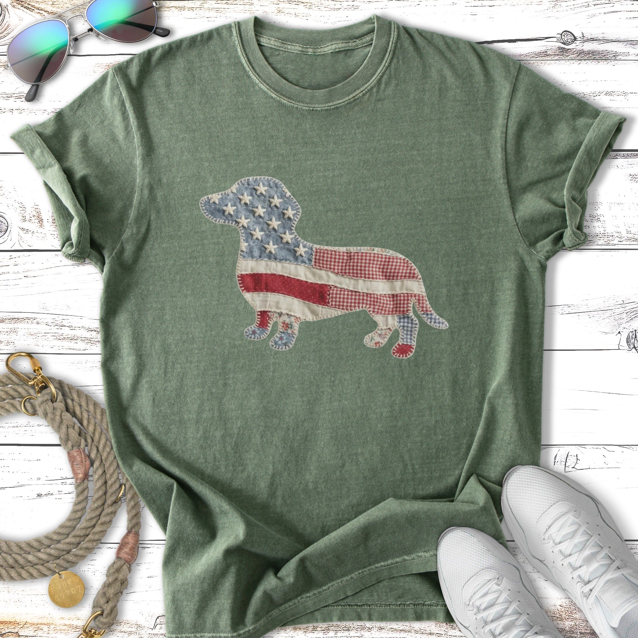 Green t-shirt with a patriotic dog graphic and white sneakers.