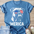 Blue t-shirt with white graphic of dog wearing American flag sunglasses and "MERICA" text.