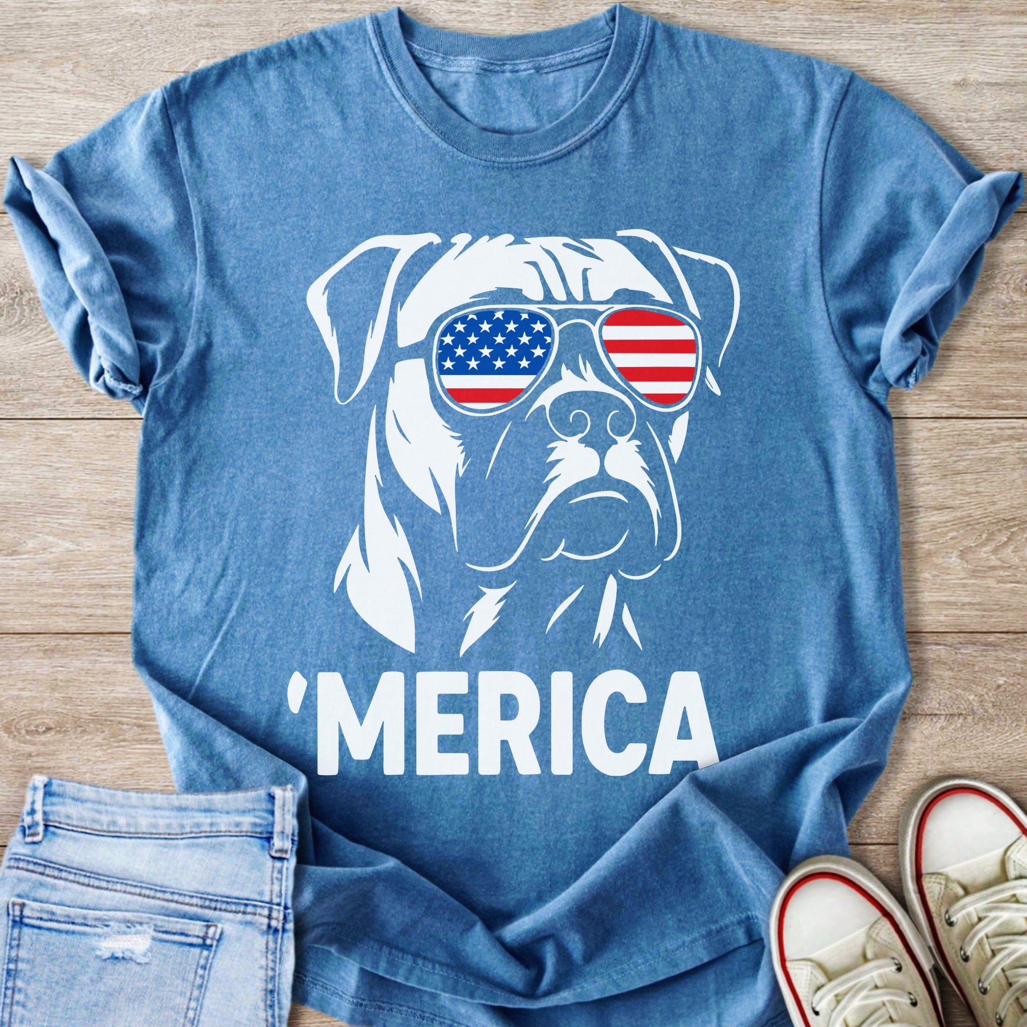 Blue t-shirt with white graphic of dog wearing American flag sunglasses and "MERICA" text.