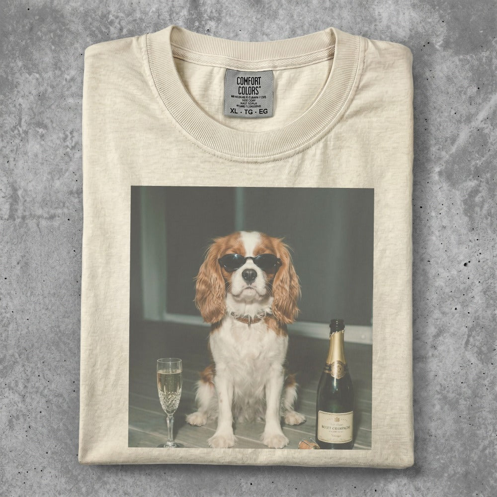 T-shirt featuring a dog in sunglasses sitting by champagne.