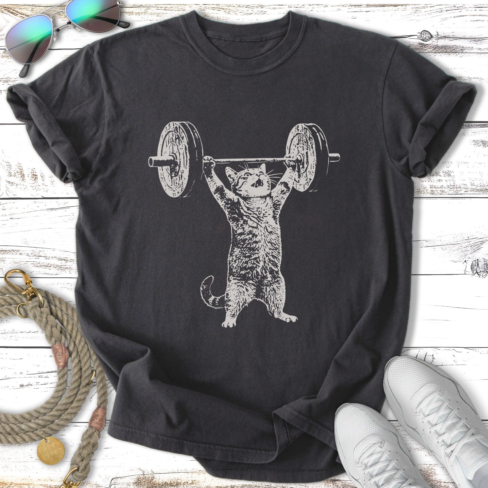 T-shirt with illustration of a cat lifting a barbell.