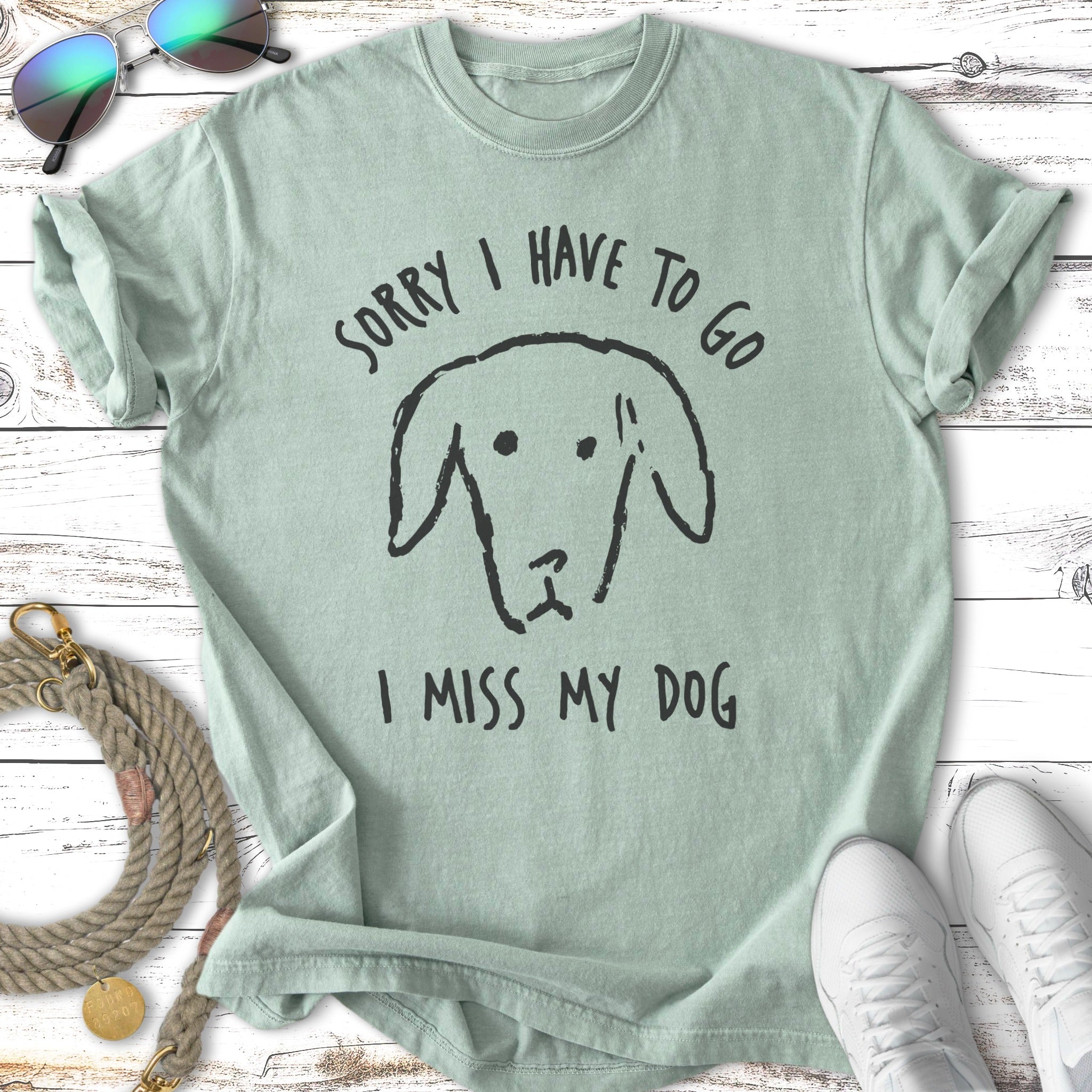 Mint green t-shirt with a black dog drawing and text "Sorry I have to go, I miss my dog".