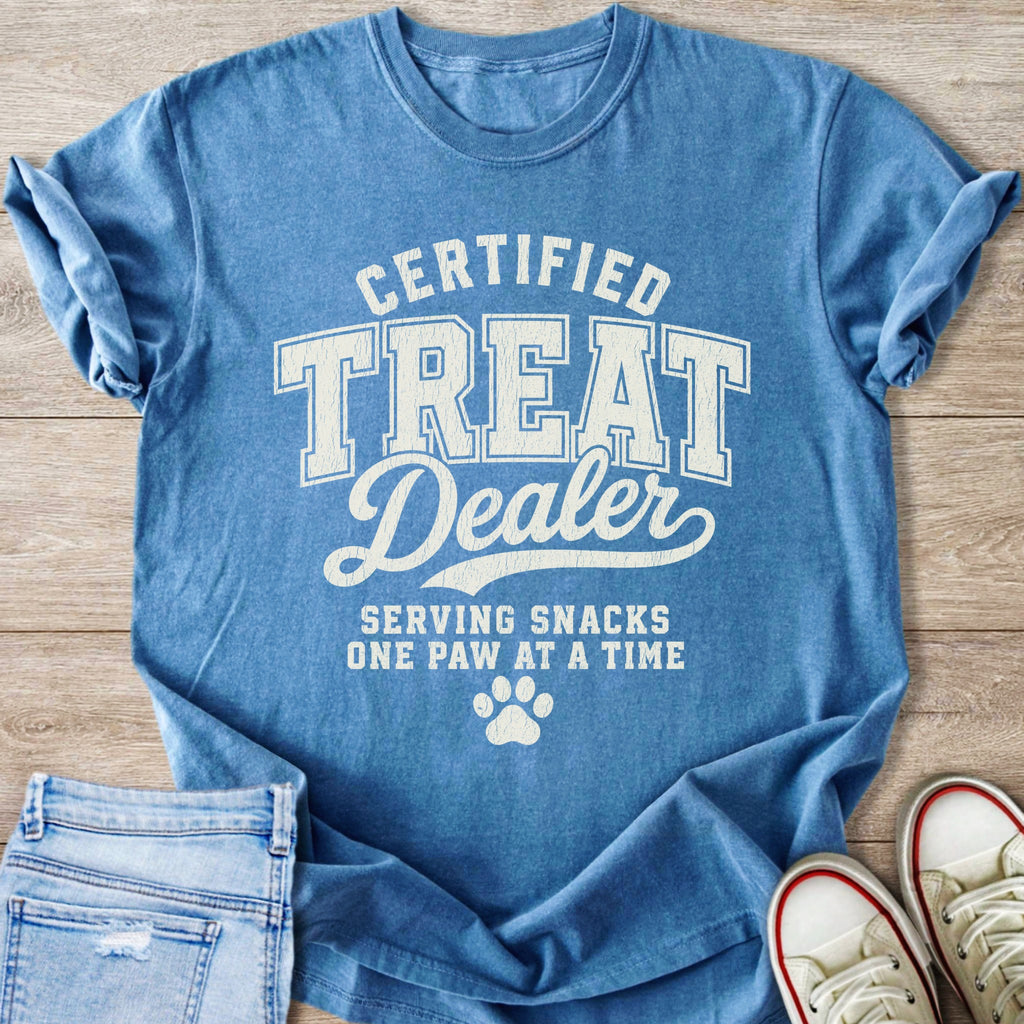 Blue t-shirt with "Certified Treat Dealer Serving Snacks One Paw at a Time" text.