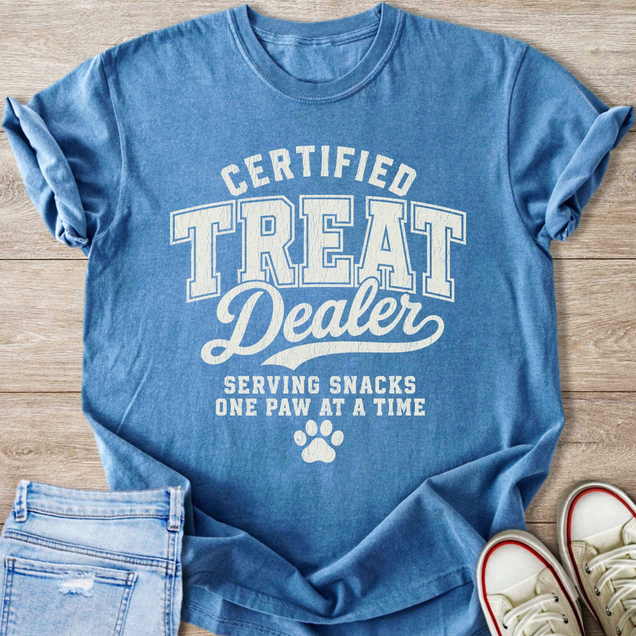 Blue t-shirt with "Certified Treat Dealer Serving Snacks One Paw at a Time" text.
