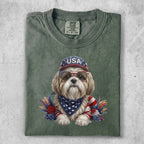 Dog wearing sunglasses and a bandana, with USA hat and floral accents.
