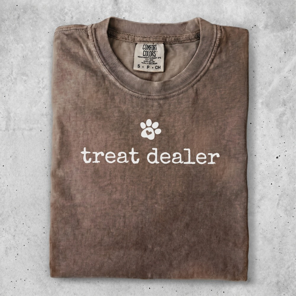 Brown Comfort Colors t-shirt with "treat dealer" and a paw print graphic.