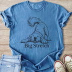 Blue t-shirt with a line drawing of a dog stretching and the words "Big Stretch".