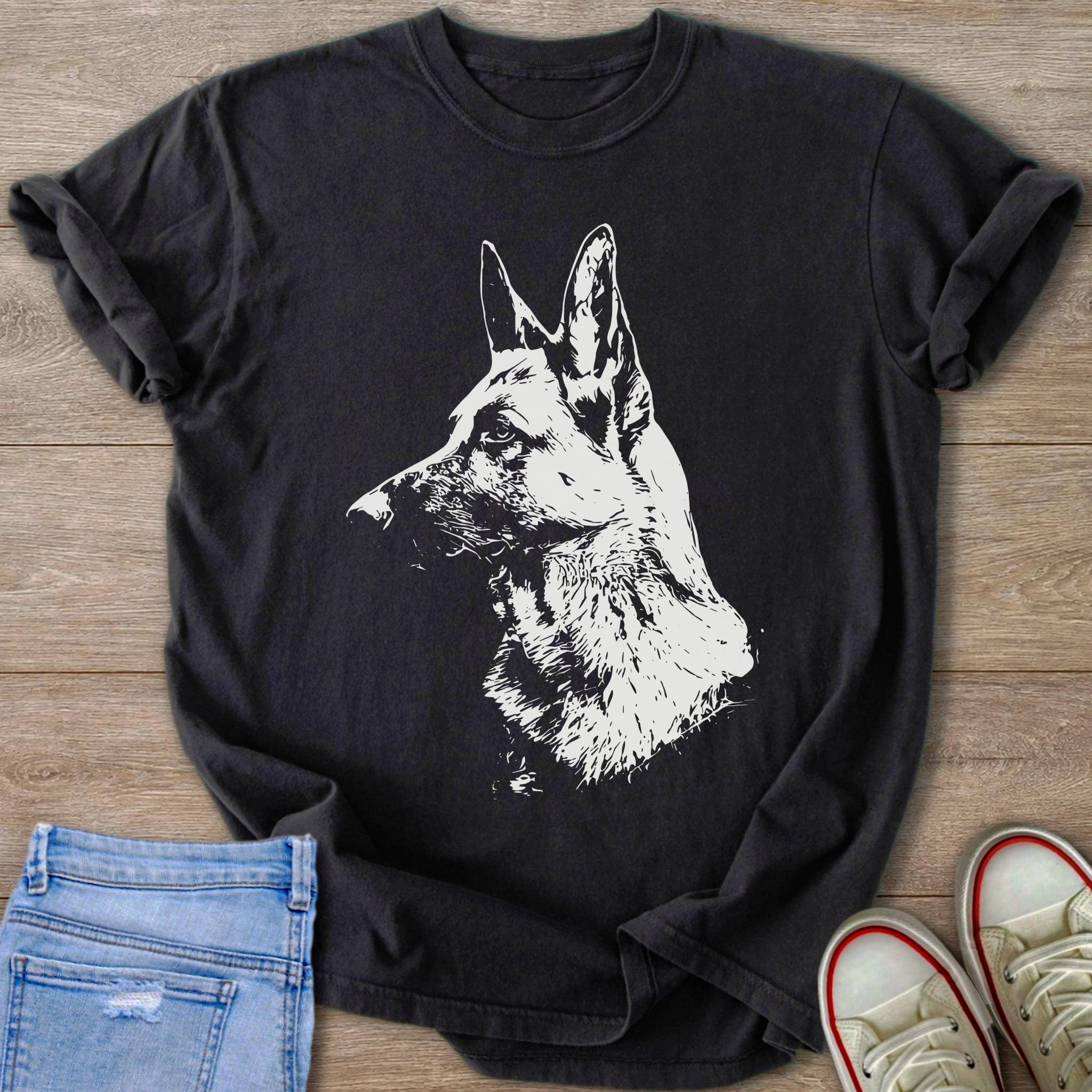 Black t-shirt with a white German Shepherd graphic on a wooden background.
