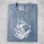 German Shepherd with dandelion illustration on faded blue t-shirt.