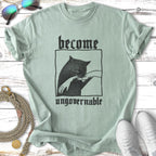 Light green t-shirt with black graphic of a cat and text "become ungovernable".