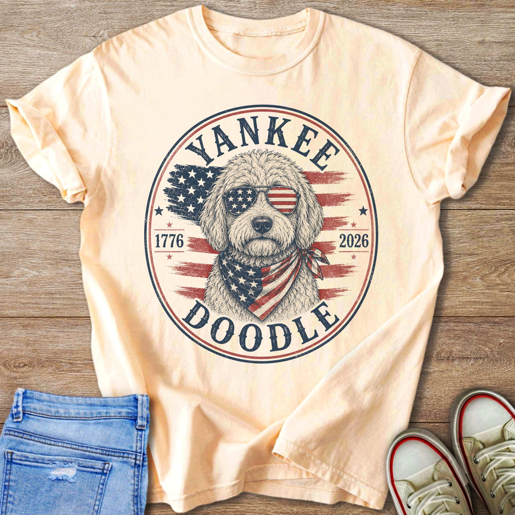 Light peach t-shirt with a circle graphic of a doodle wearing sunglasses and bandana.