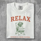 White t-shirt with pug in a chair wearing sunglasses and hat, text "RELAX" and "NOTHING IS UNDER CONTROL".