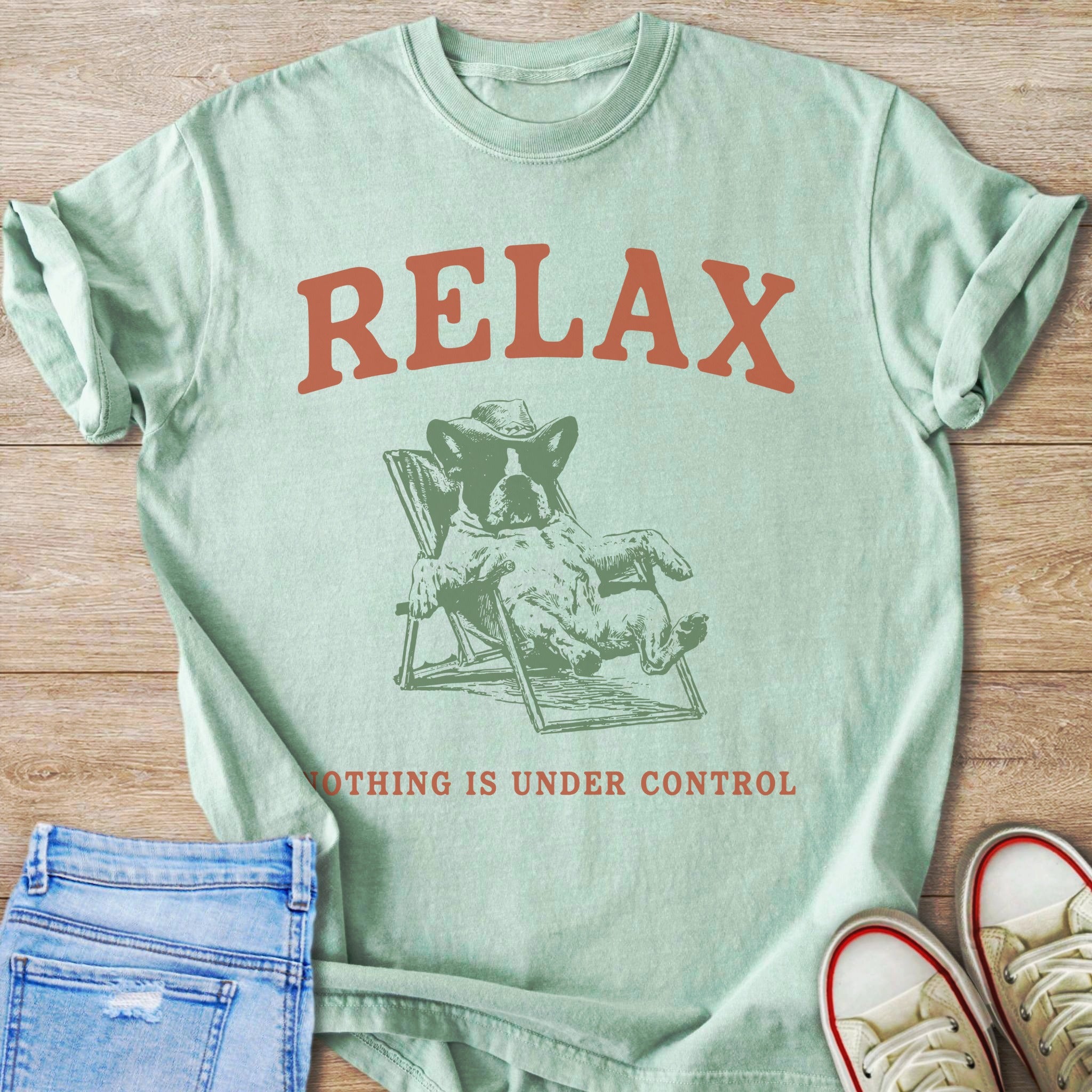 Mint green t-shirt with rust text "RELAX" and French bulldog in cowboy hat.