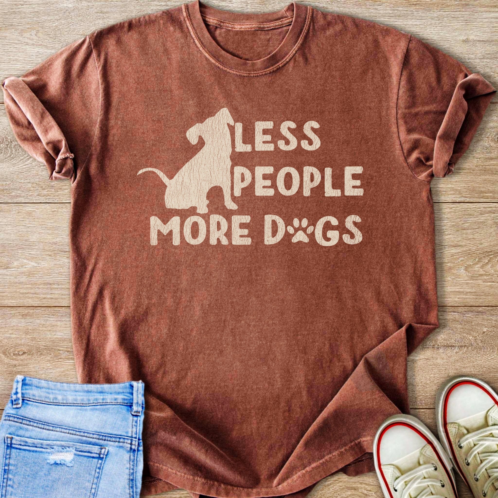Rust colored t-shirt with dog silhouette and text "LESS PEOPLE MORE DOGS".