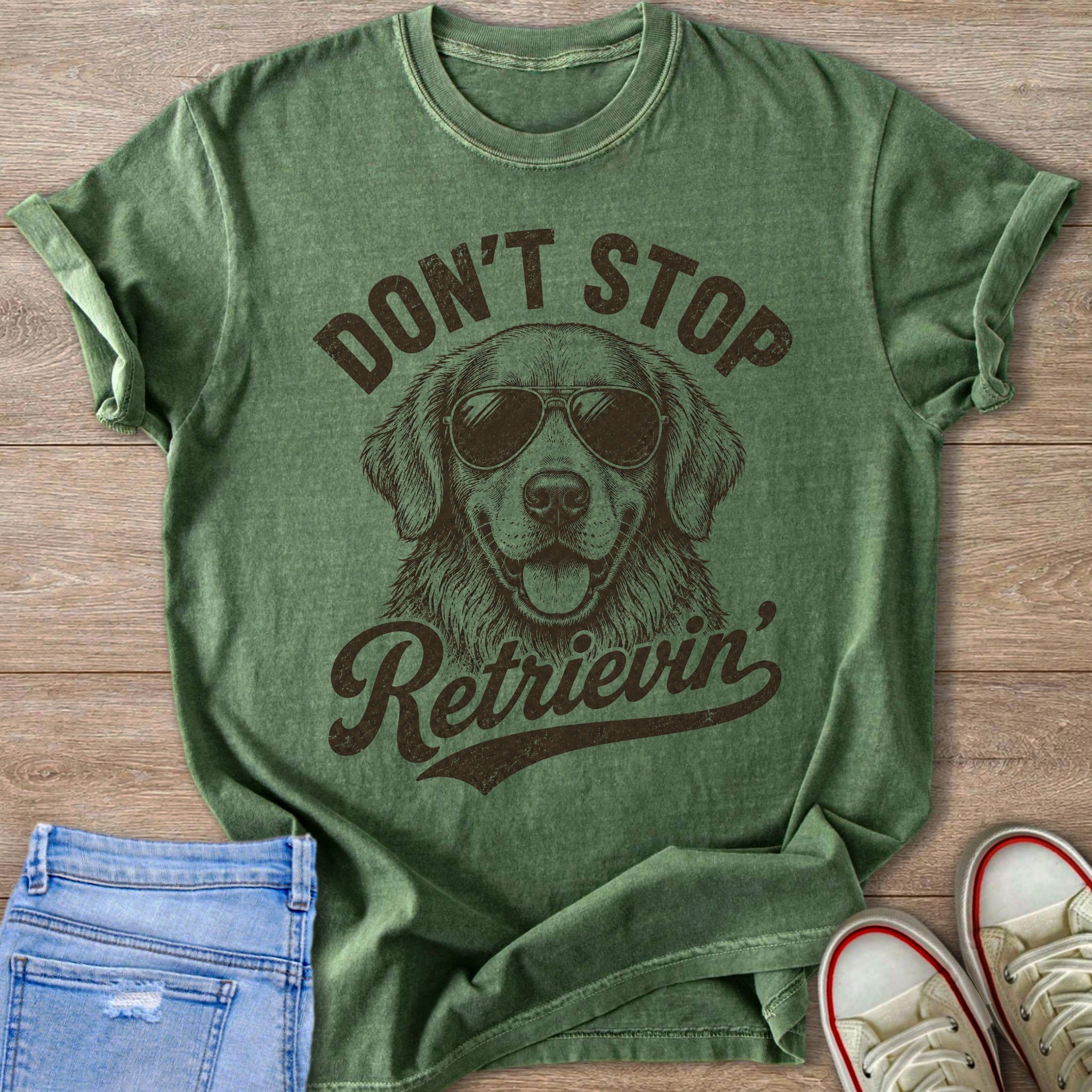 Green t-shirt with a golden retriever wearing sunglasses and text "Don't Stop Retrieving".