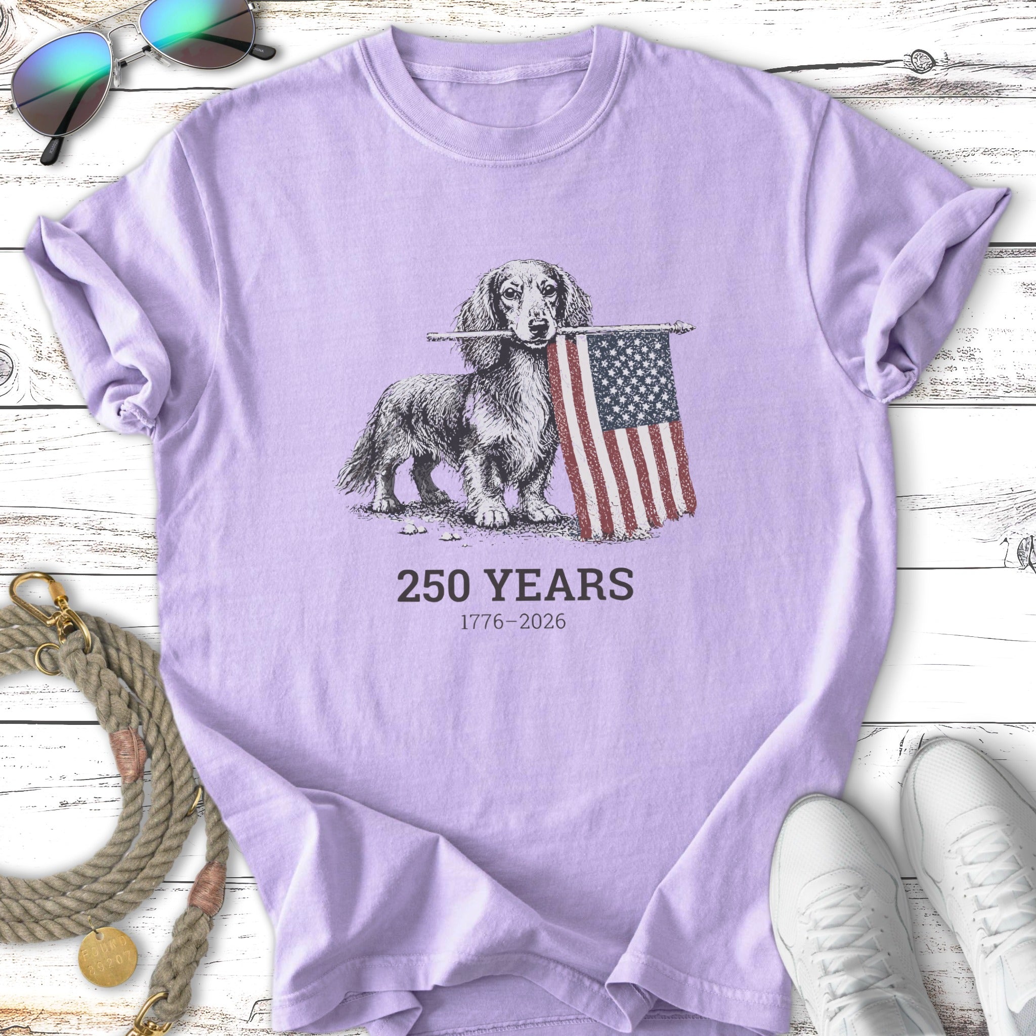 Dachshund holding American flag with "250 YEARS 1776-2026" text.