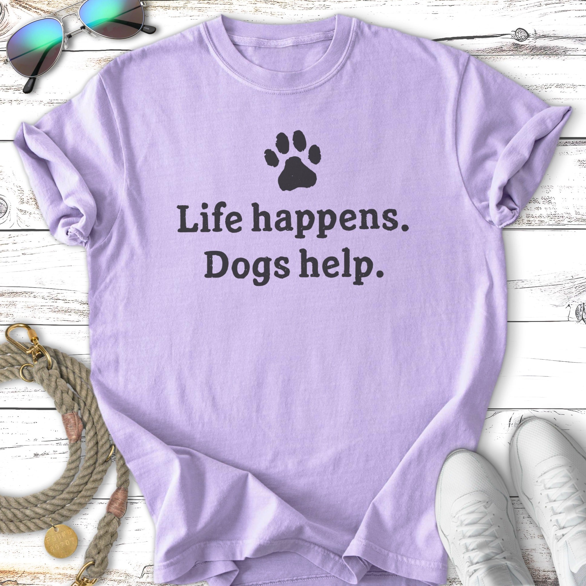 Lilac t-shirt with "Life happens. Dogs help." text and paw print.