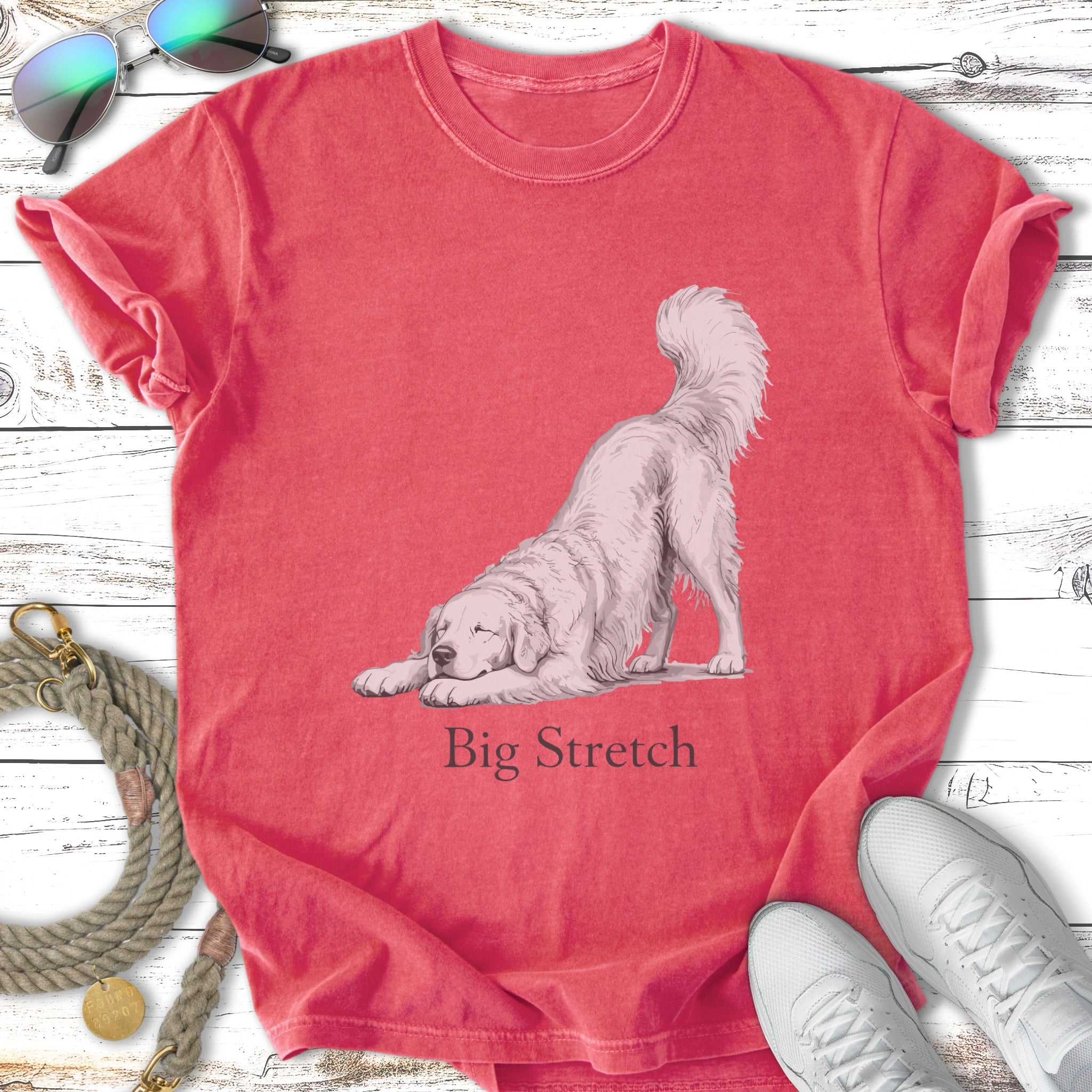 White dog in a "Big Stretch" pose on a coral t-shirt.