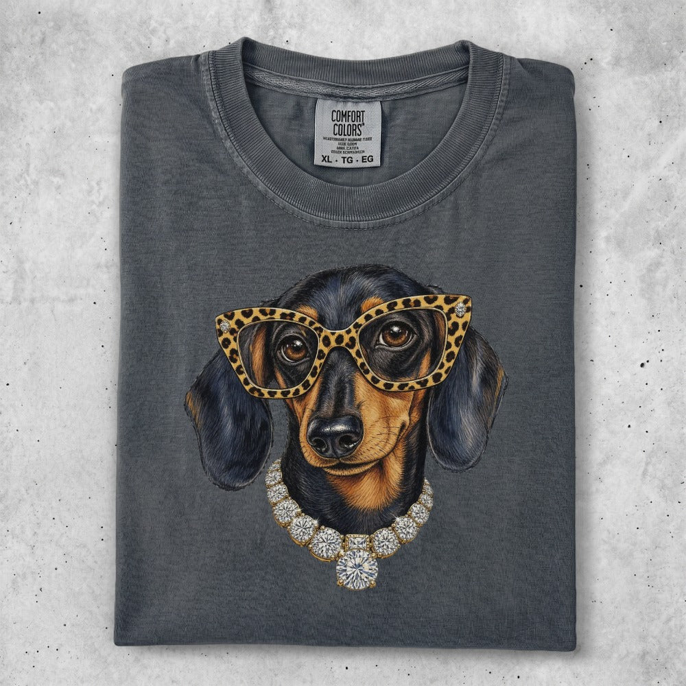 Dachshund wearing glasses and diamond necklace on charcoal t-shirt.