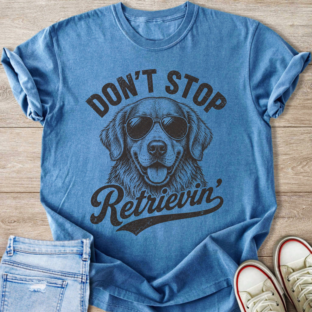 Blue t-shirt with sketch of a dog wearing sunglasses and text "Don't Stop Retrieving".