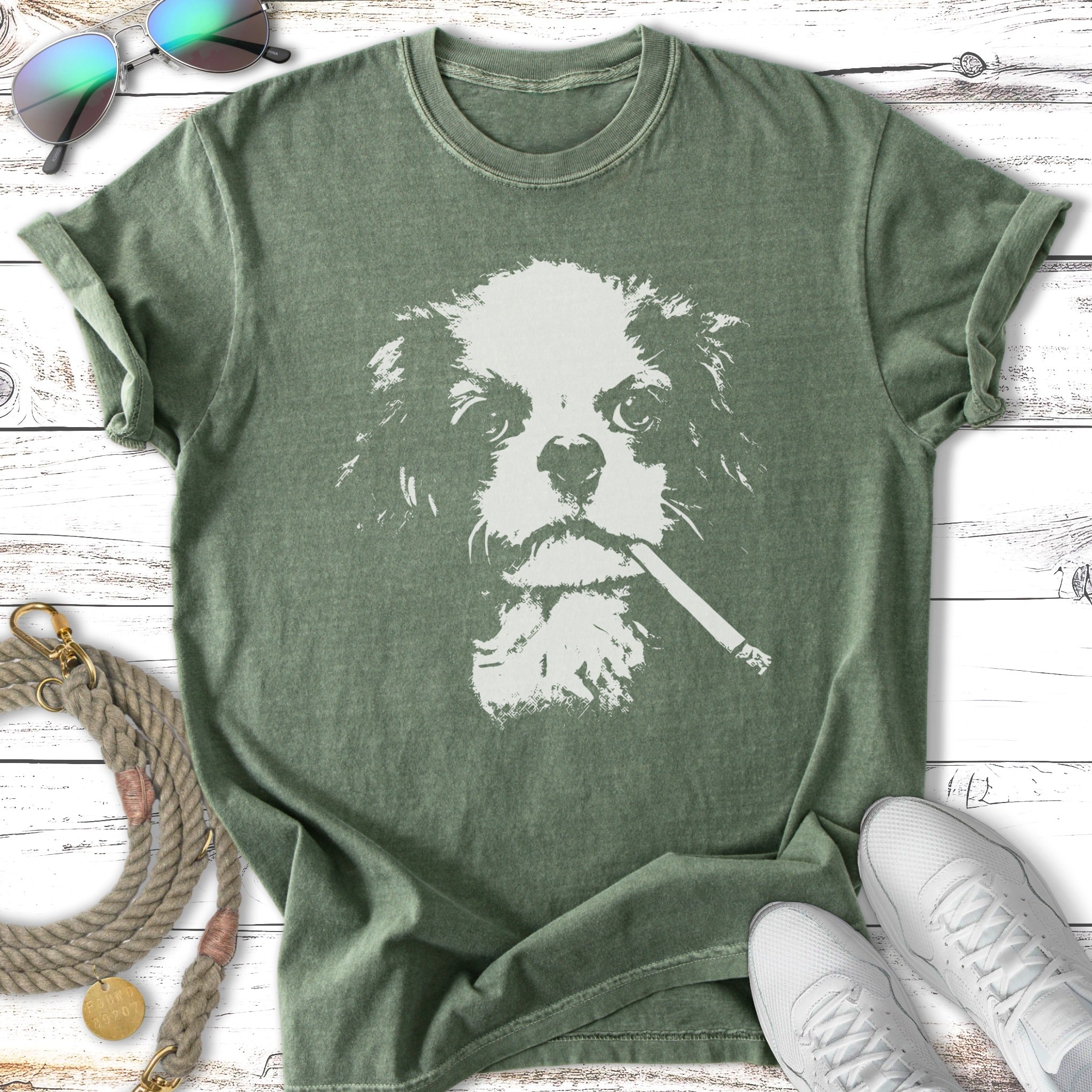 Green t-shirt with white distressed graphic of a Cavalier King Charles Spaniel smoking a cigarette.