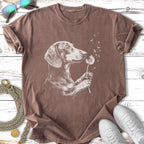 Dachshund sniffing dandelions on a brown t-shirt.