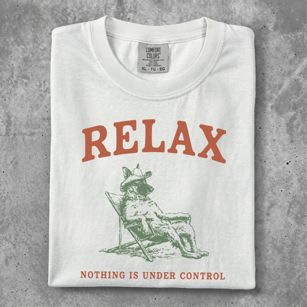 White t-shirt with "RELAX" and a dog in a chair, "NOTHING IS UNDER CONTROL".