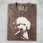 Brown t-shirt with white poodle graphic smoking a cigarette.