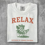 White t-shirt with "RELAX" and a dog in a camping chair.