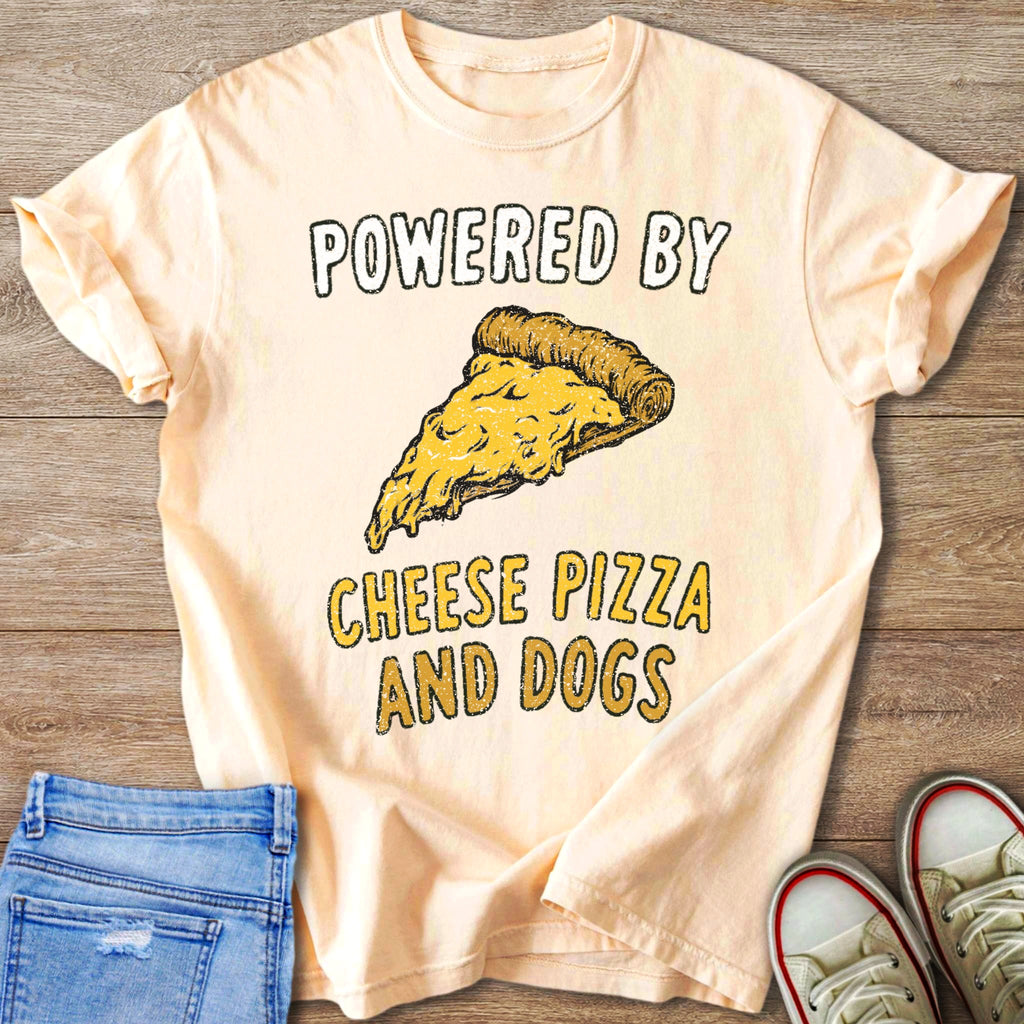 Peach t-shirt with "Powered By Cheese Pizza And Dogs" and a pizza slice graphic.