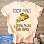 Peach t-shirt with "Powered By Cheese Pizza And Dogs" and a pizza slice graphic.
