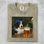 Border collie wearing a blue baseball cap looks at a beer being poured into a mug.