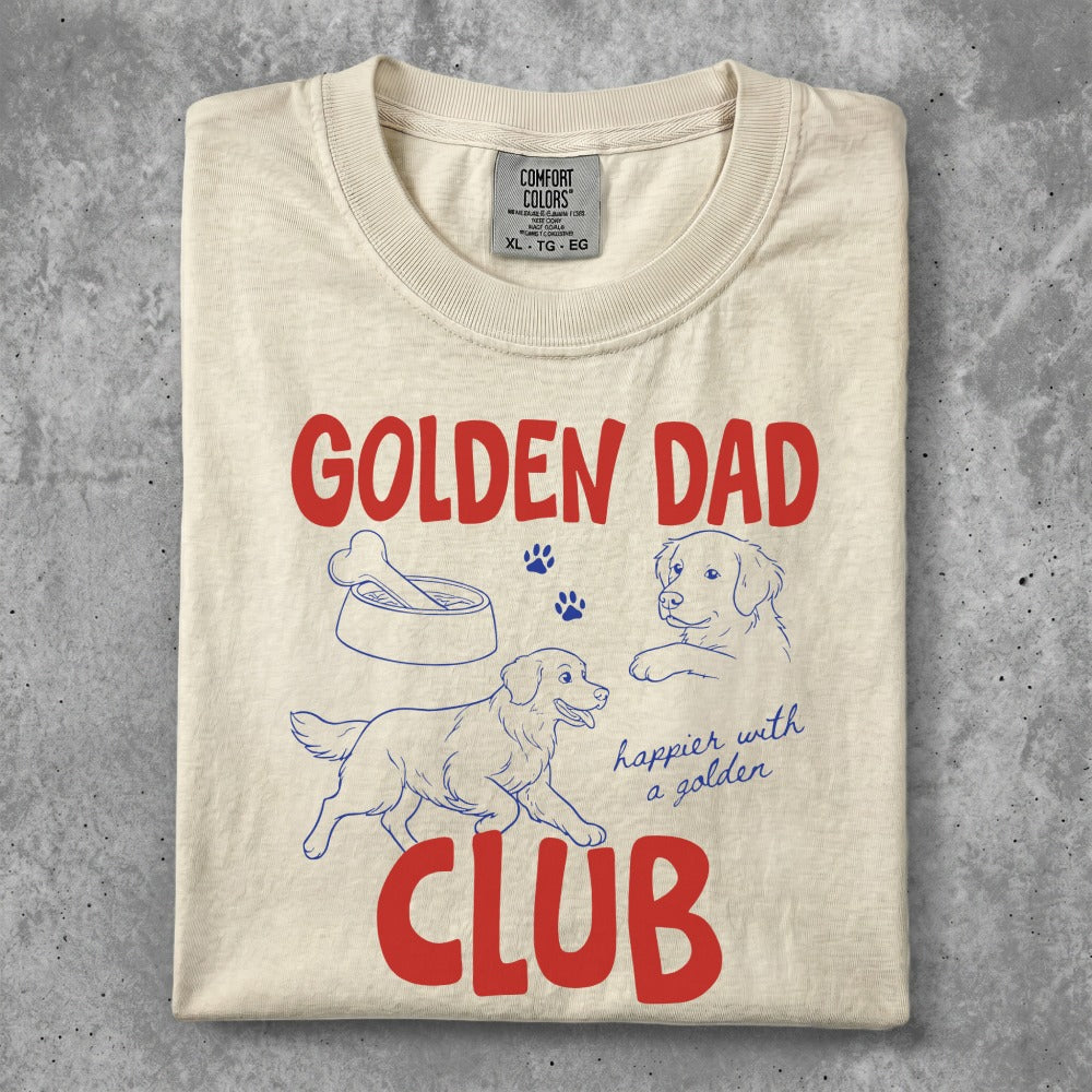 Cream t-shirt with "Golden Dad" and "Club" in red lettering with dog imagery.
