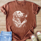 Brown t-shirt with white line art of a dog holding a dandelion.