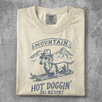 Dachshund in sunglasses on skis at "Hot Doggin' Ski Resort" vintage graphic.