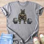 Muscle-bound French bulldog lifting a barbell on a grey t-shirt.